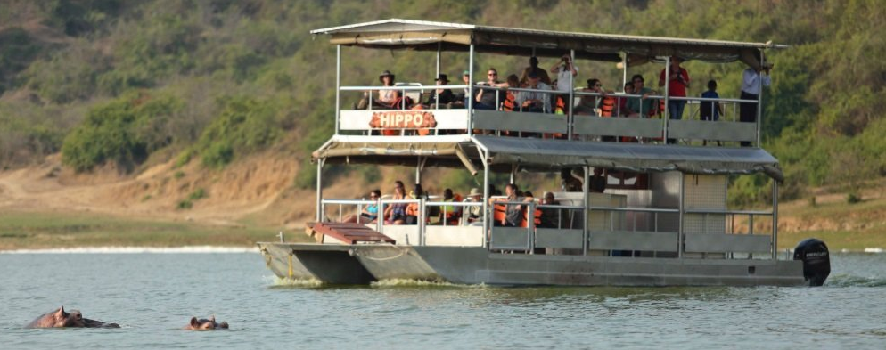 Boat cruise on the Kazinga Channel during a 6-day Uganda safari, viewing hippos and wildlife.